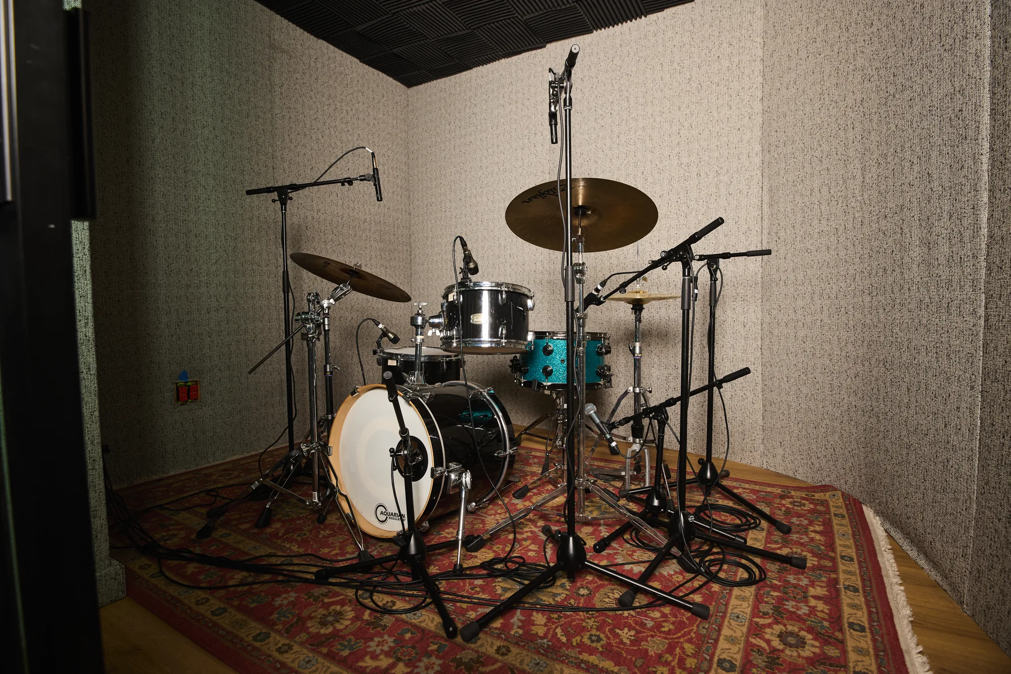 A mic'd drum kit in the iso booth at The Recording Club